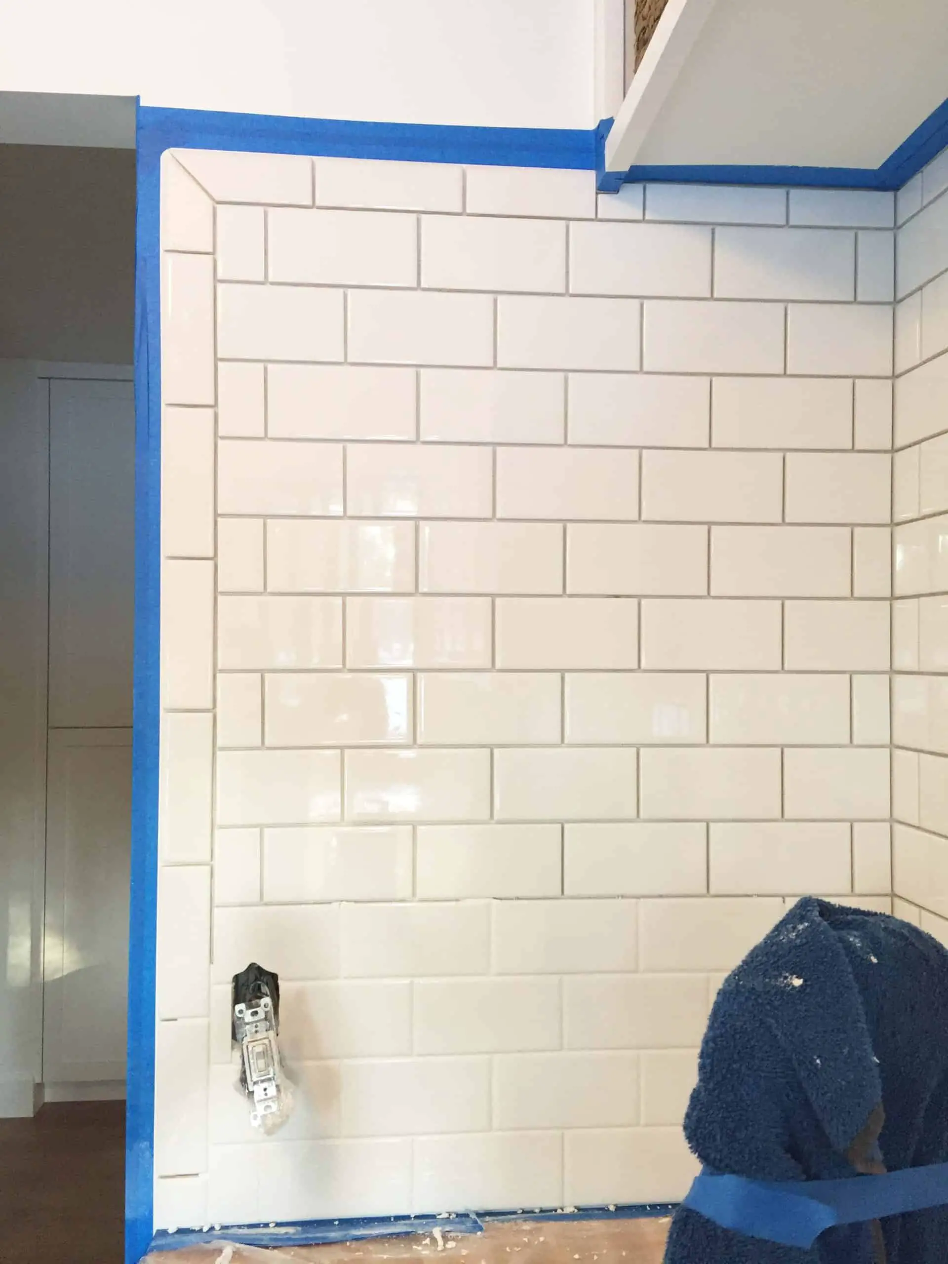 tall white subway tile backsplash in modern farmhouse laundry room 