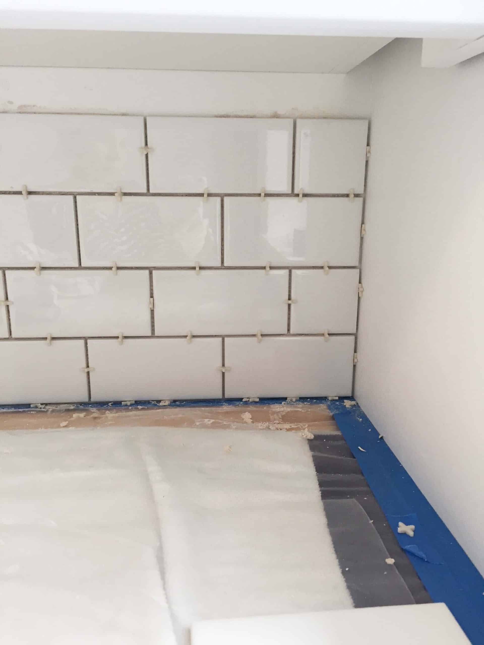 white subway tile backsplash in laundry room with 1/8 inch spacers