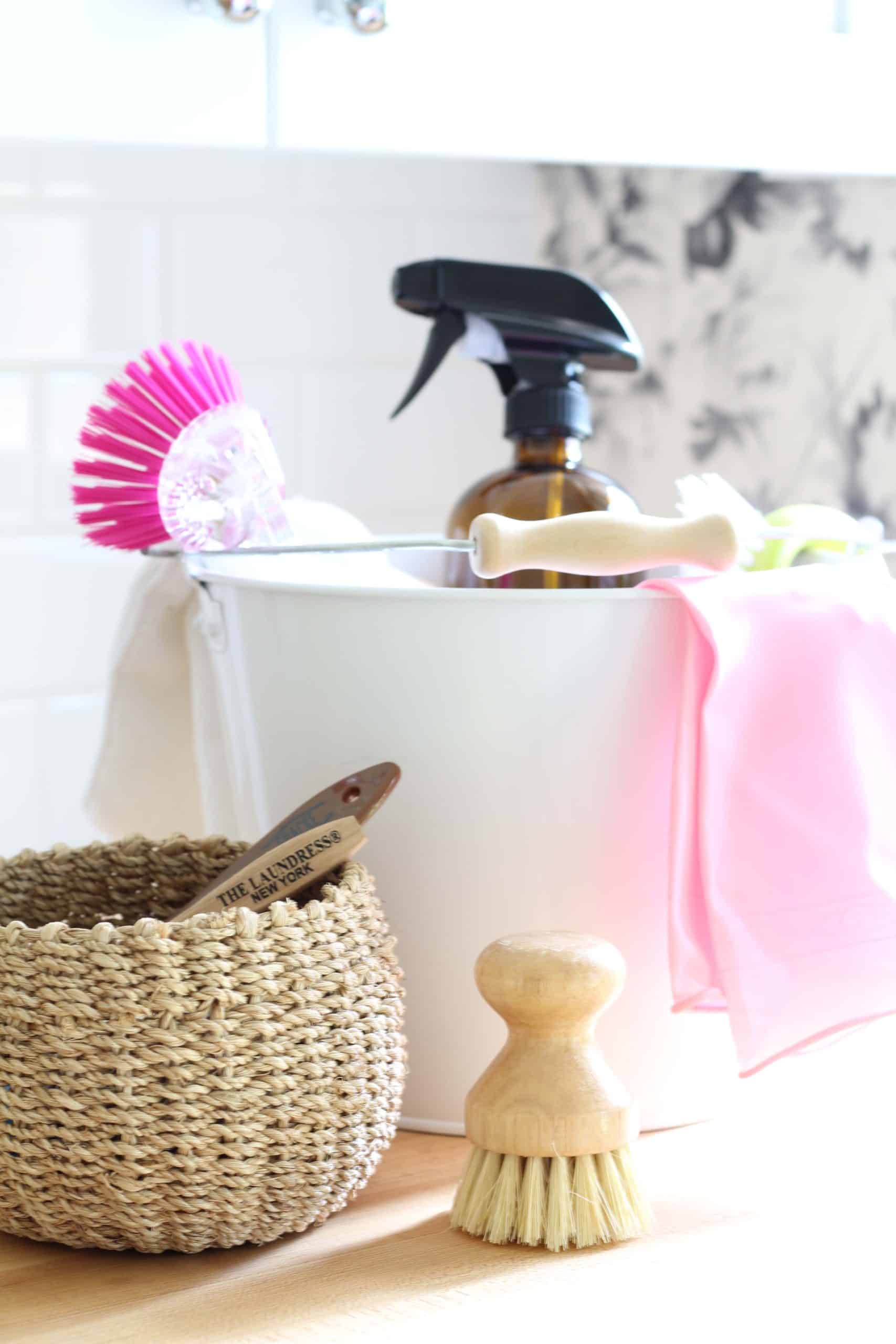 white metal cleaning bucket with wood handle, amber glass cleaning bottle, wood scrub brush, house of hackney smokey rose wallpaper