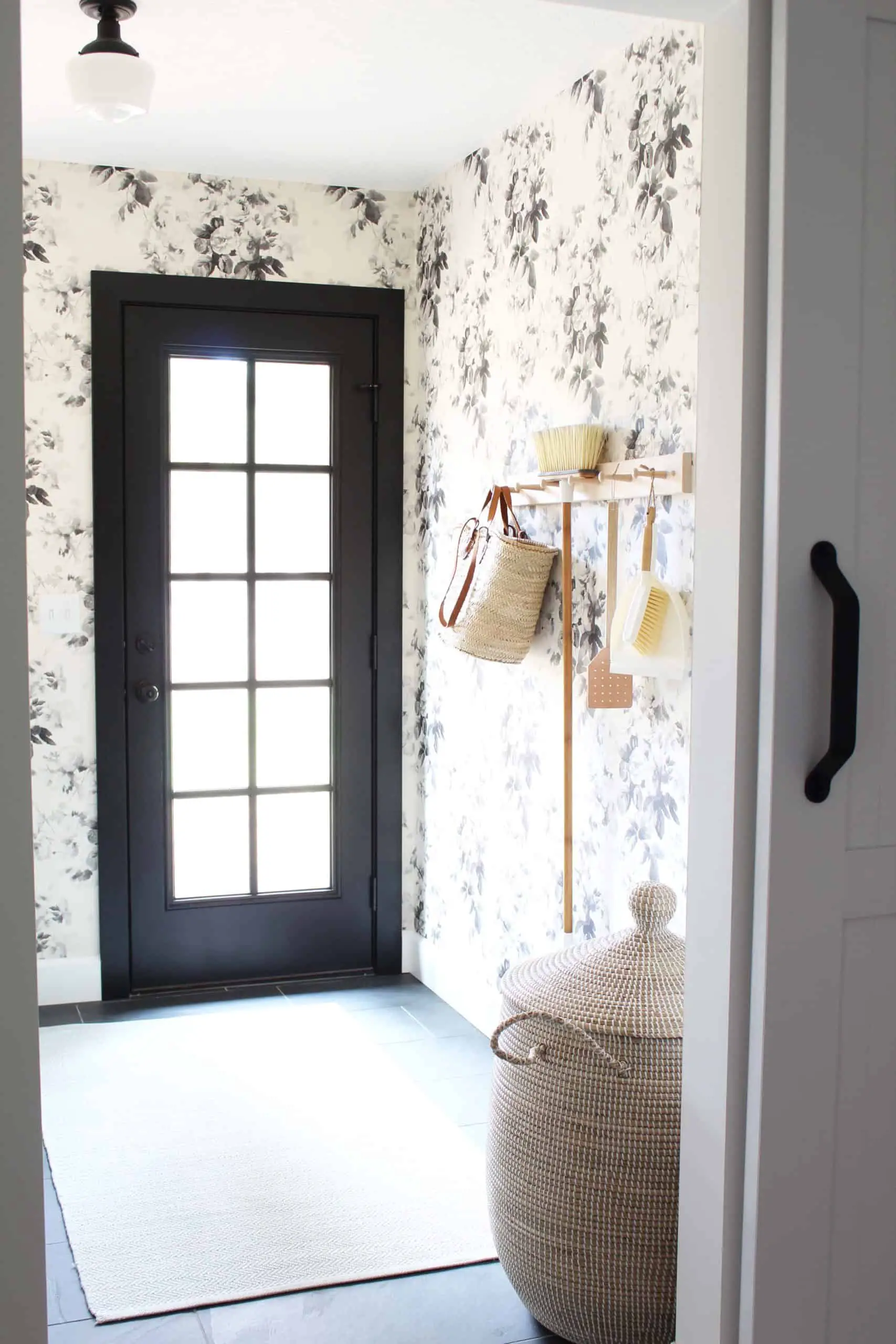 laundry room with anthropologie black and white floral wallpaper 