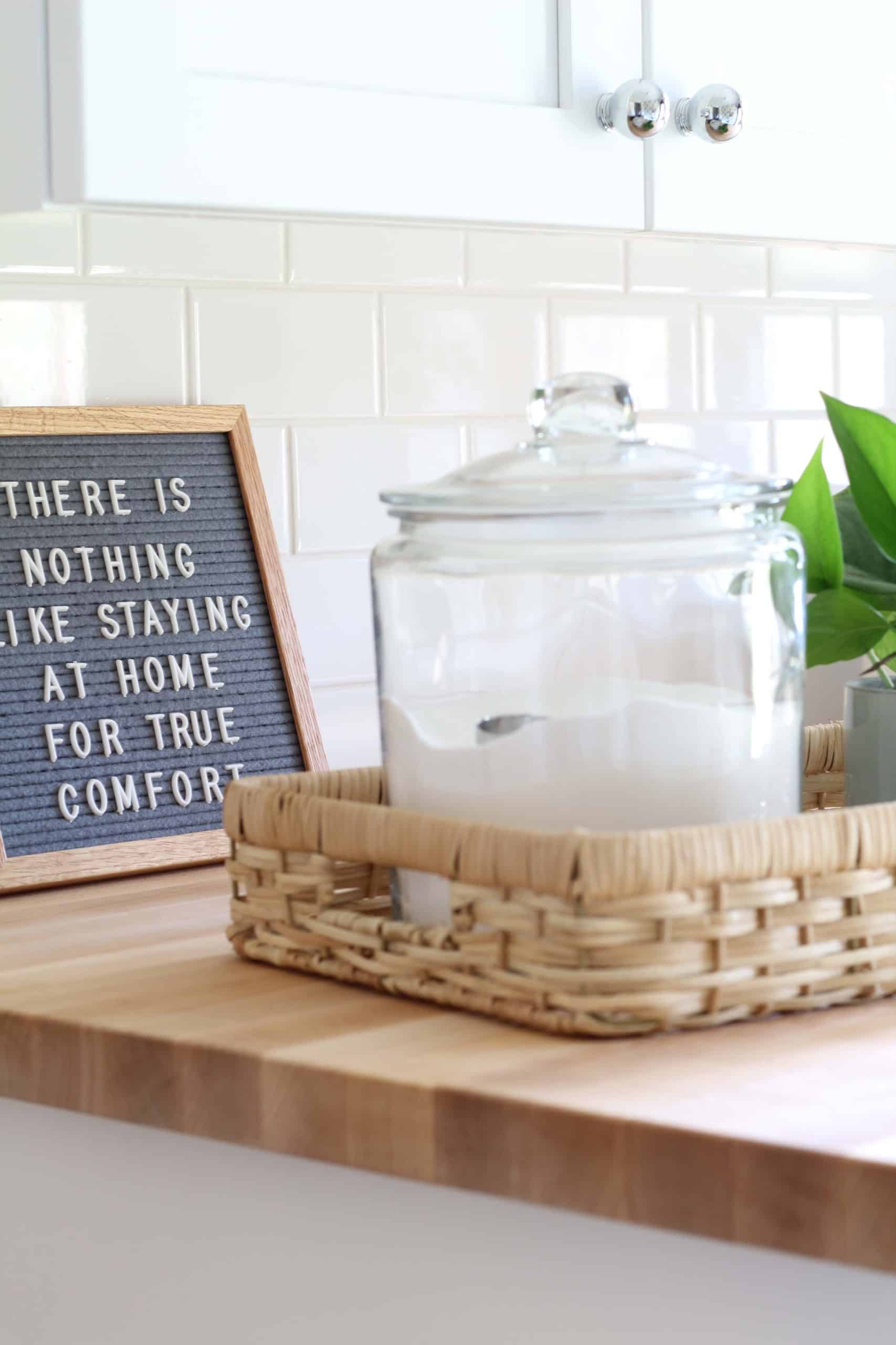 gray felt letter board, glass canister with laundry soap, maple butcher block countertops