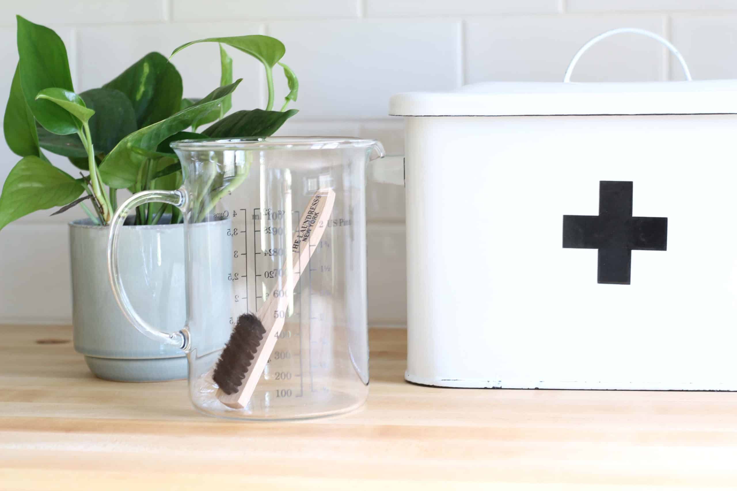 creative co-op white enamel first aid box with black cross, ikea measuring cup, white subway tile backsplash, make butcher block countertop