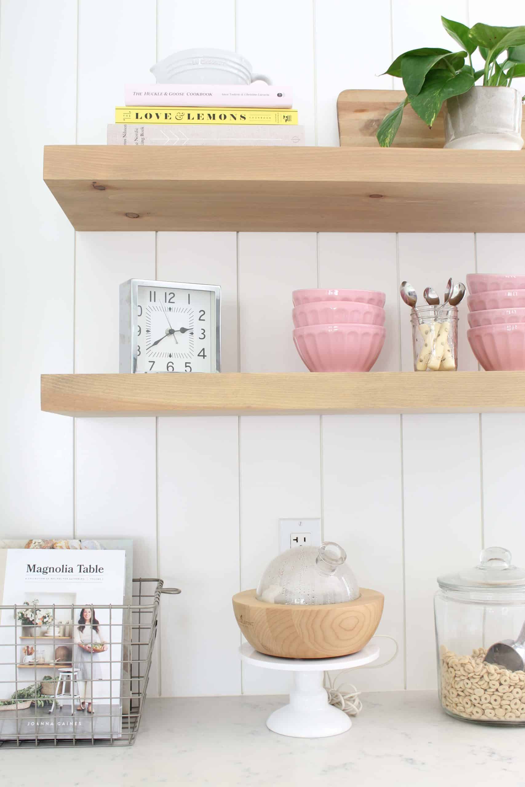 anthropologie pink latte bowls, gold polka dot coffee spoons, le crueset juicer, pathos in studio mcgee plant pot, magnolia home cookbook