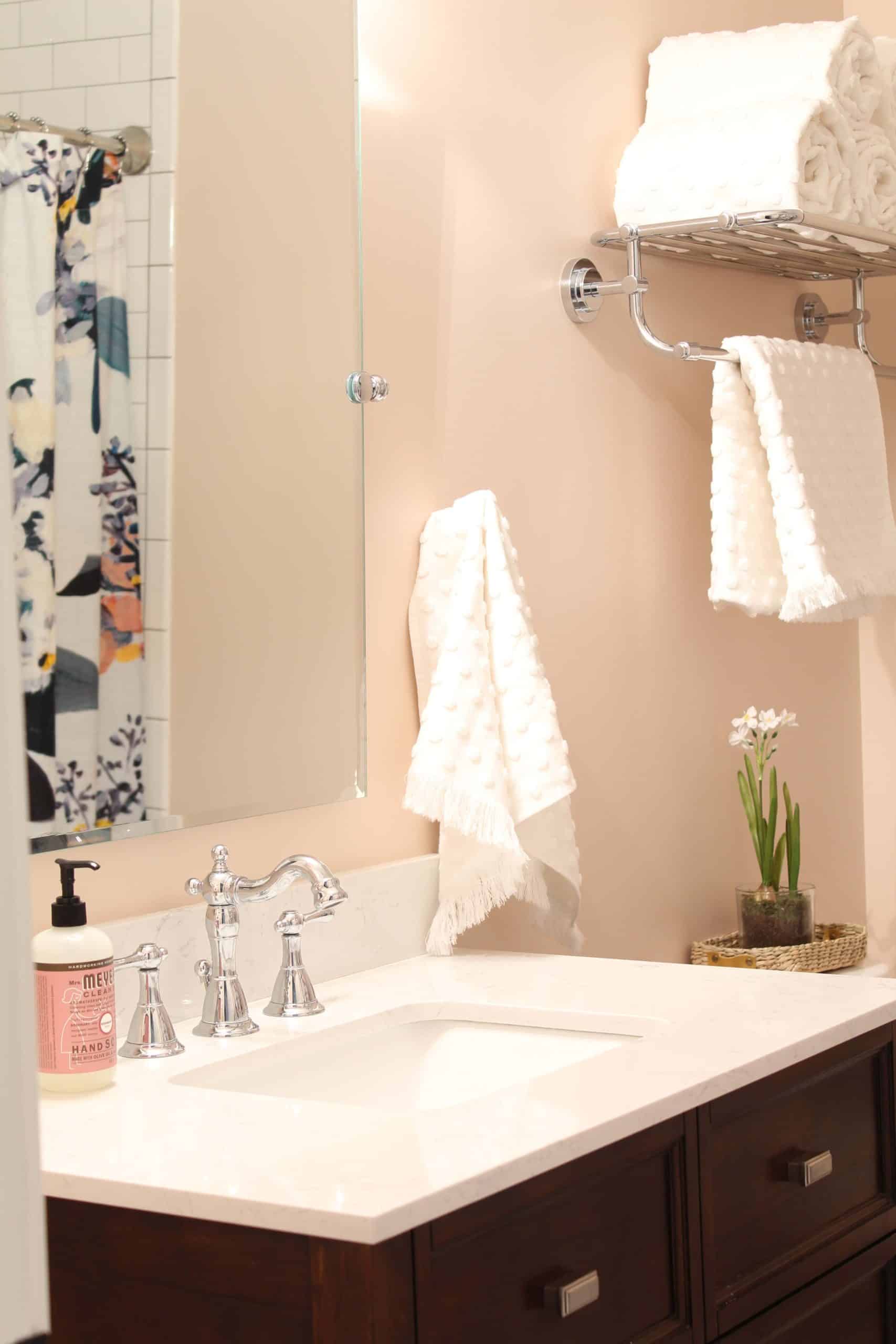 anthropologie botanica shower curtain, bathroom with pink walls, white polka dot towels, white subway tile shower surround, bathroom with hotel towel rack