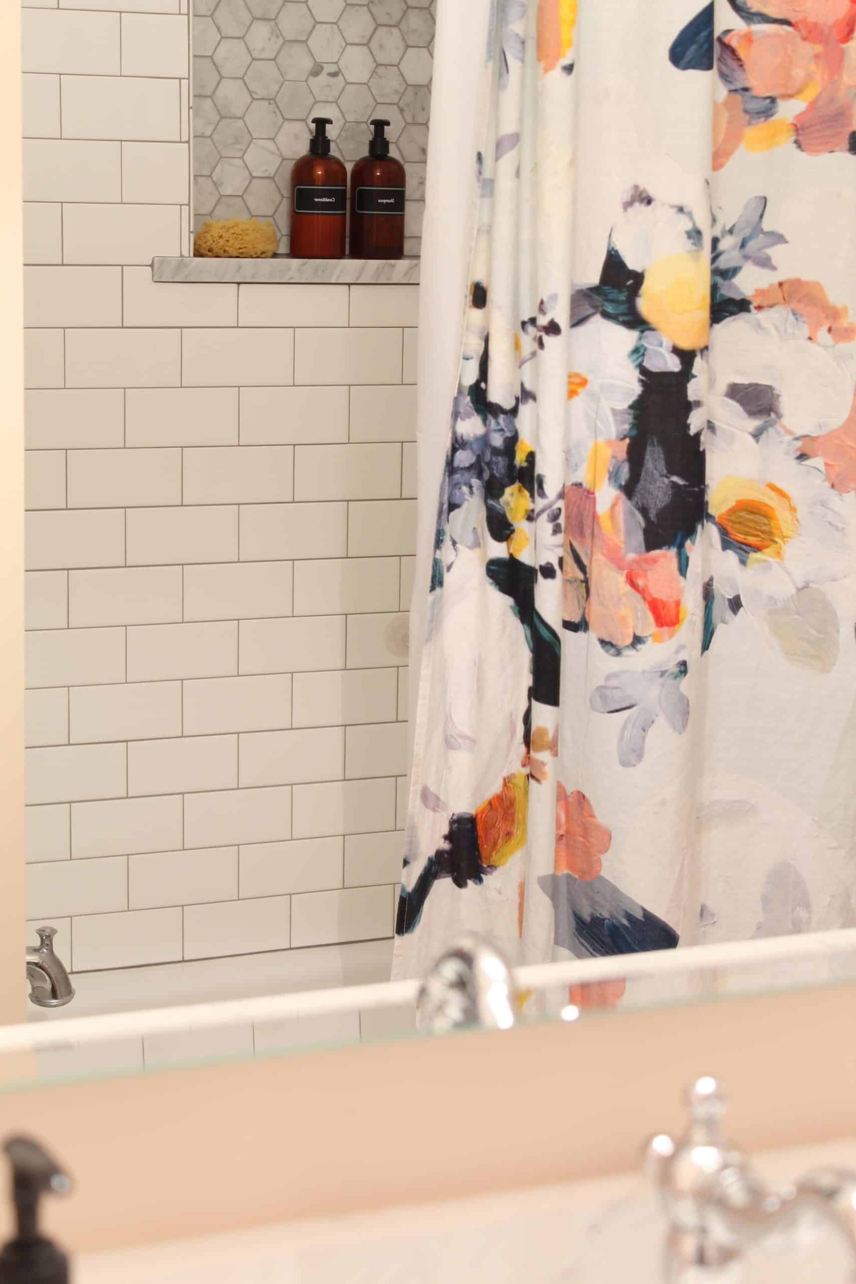 anthropologie botanica shower curtain, bathroom with pink walls, white subway tile shower surround,