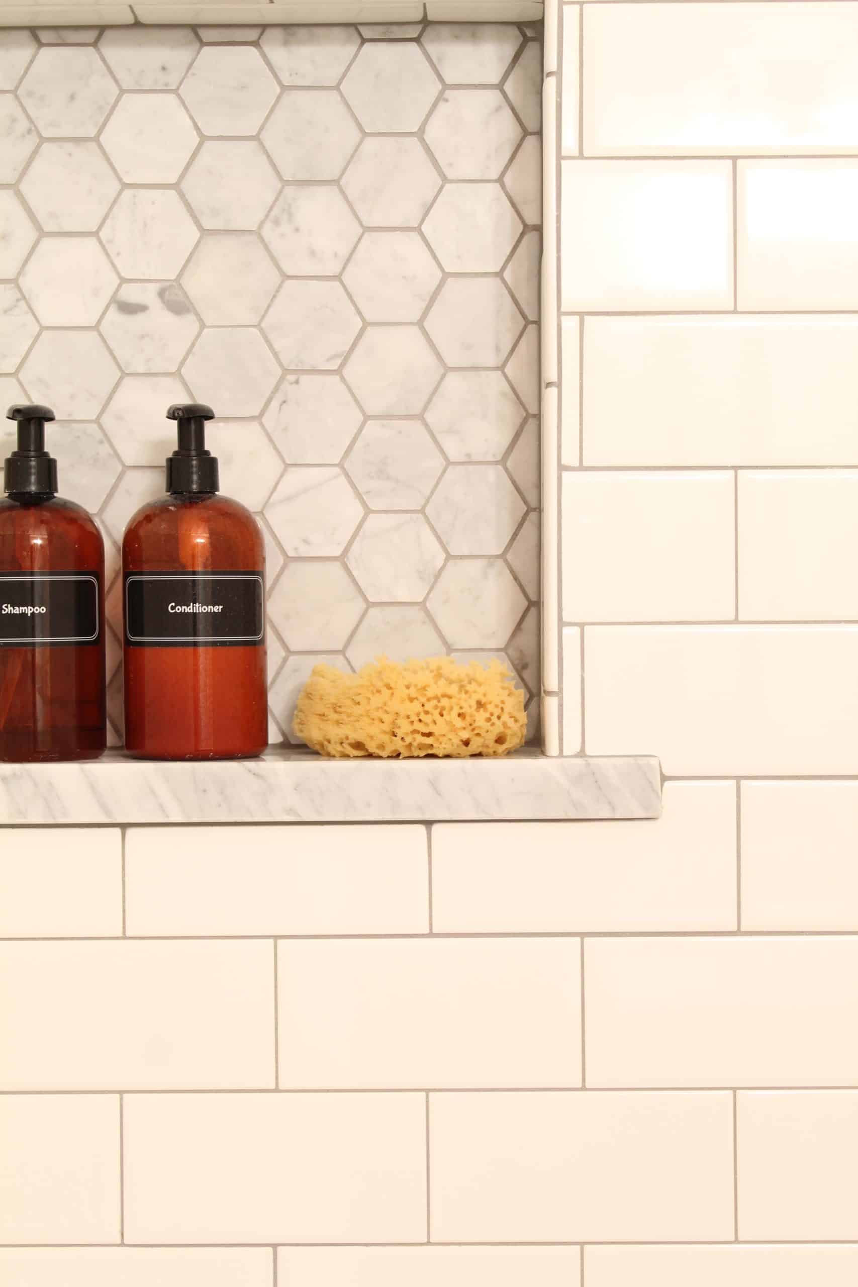 anthropologie botanica shower curtain, bathroom with pink walls, white subway tile shower surround, amber shampoo and conditioner bottles