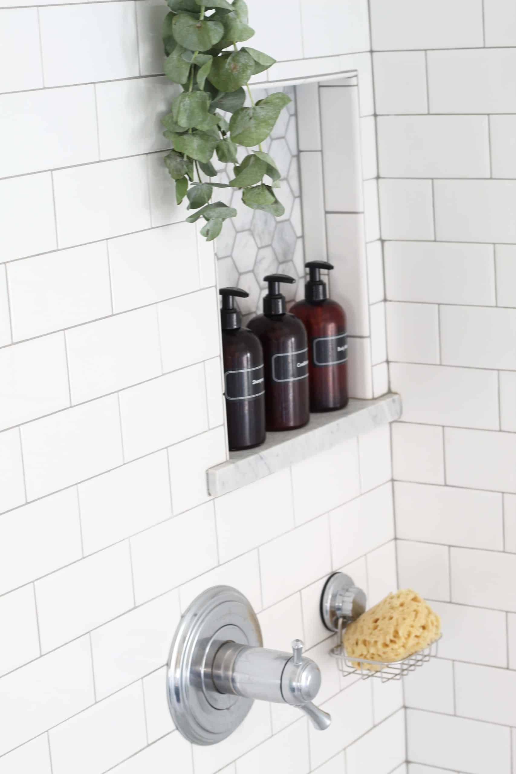 eucalyptus hanging in shower with amber pump shower bottles