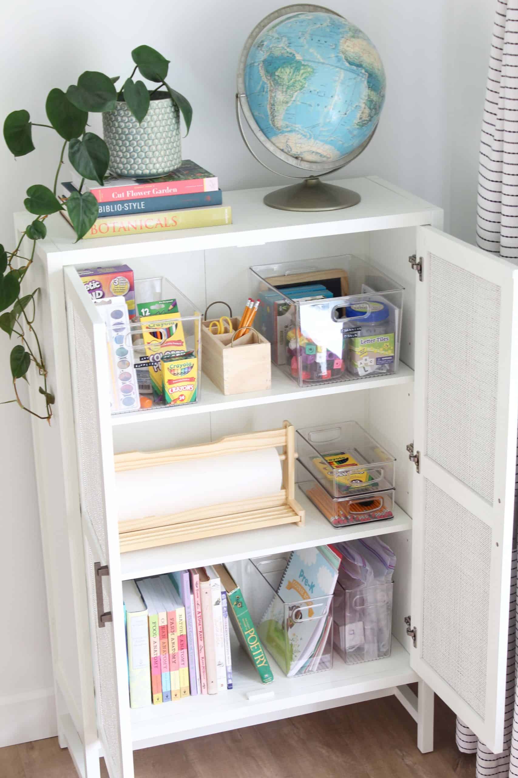 target warwick library cabinet in white, vintage globe, heart leaf philodendron, ikea paper dispenser, homeschool supplies, homeschool cabinet