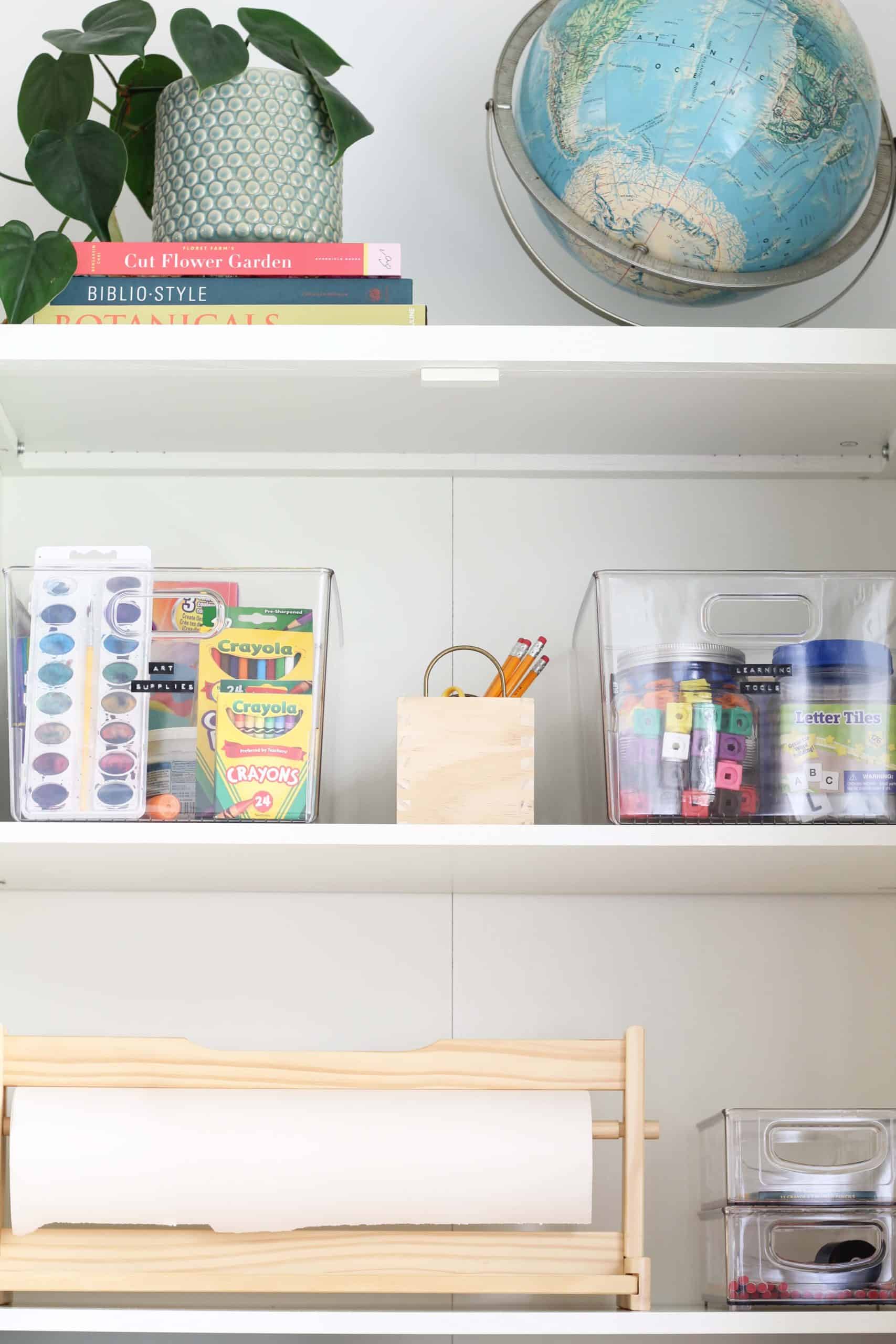 target warwick library cabinet in white, vintage globe, heart leaf philodendron, ikea paper dispenser, homeschool supplies, homeschool cabinet