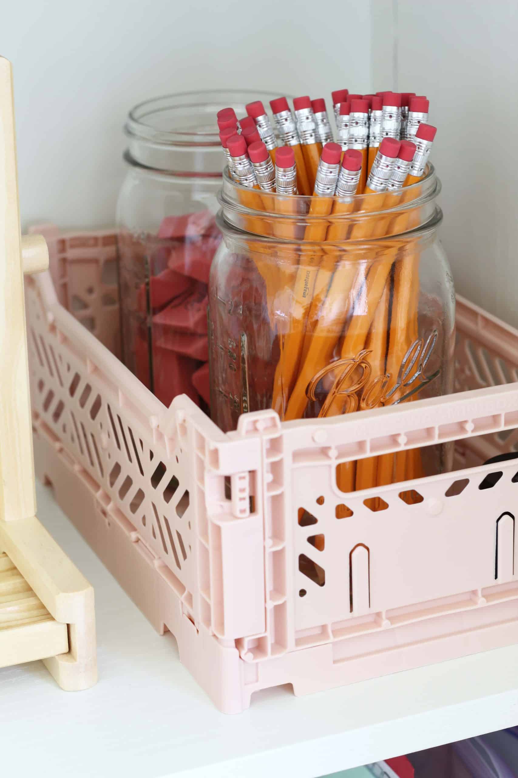 pencils in wide mouth ball jar, pink pearl erasers in wide mouth ball jar, pink hay crate, pink milk crate