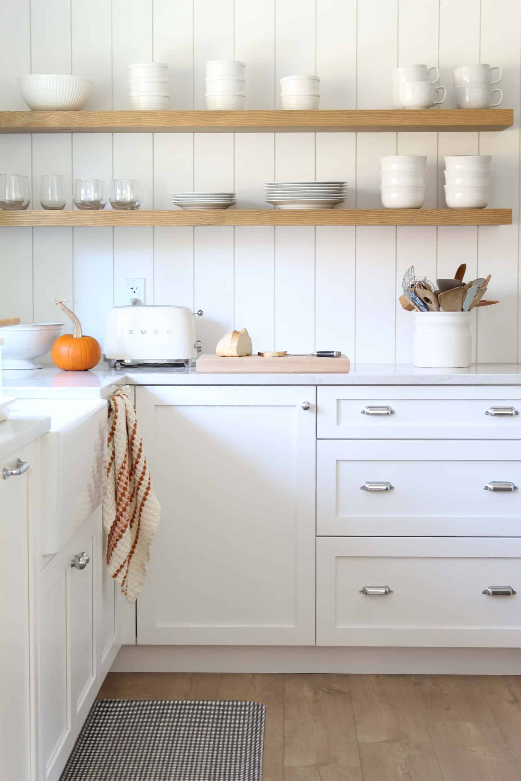 open kitchen shelving with white dished and smeg toaster