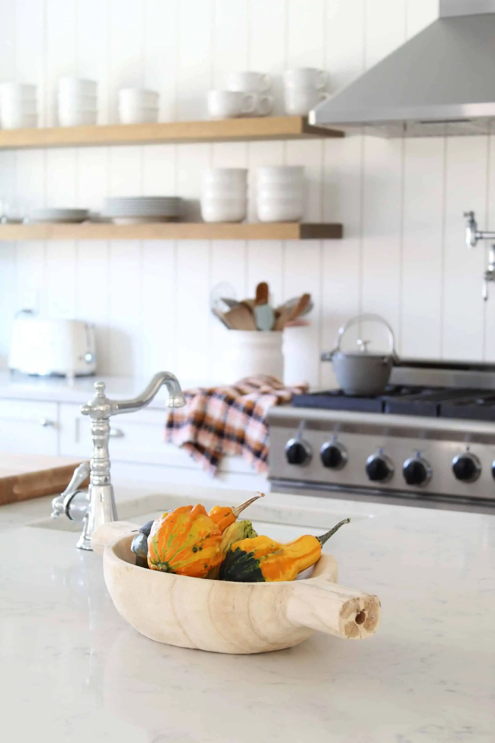 gourds in wood dough bowl, white farmhouse kitchen 