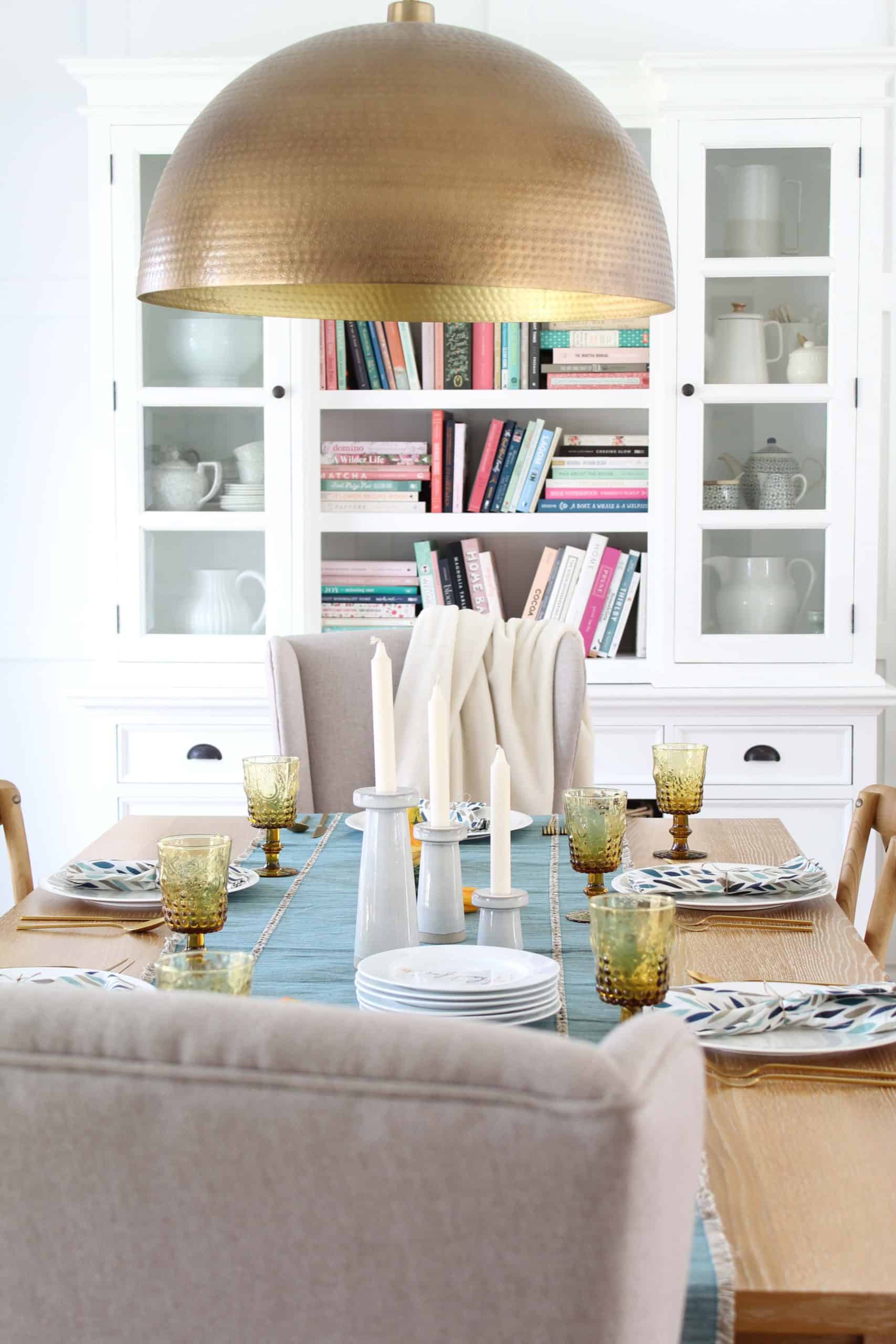 crate and barrel brass pendant light hanging over table