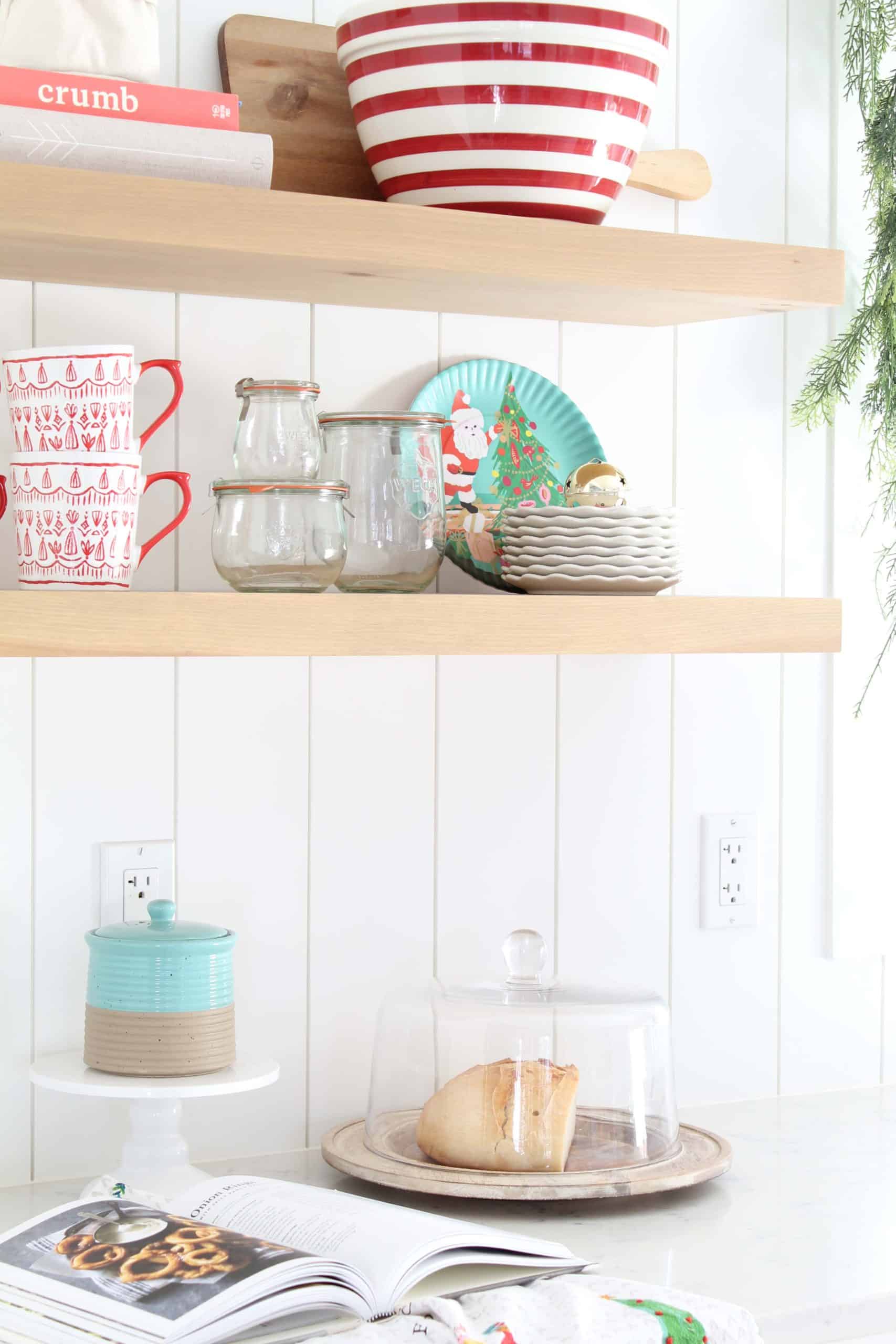 farmhouse kitchen with open shelving, crate and barrel red striped bowl, tulip wreck jars, melamine christmas plates, mr. boddington tea towel, anthropologie tea towel