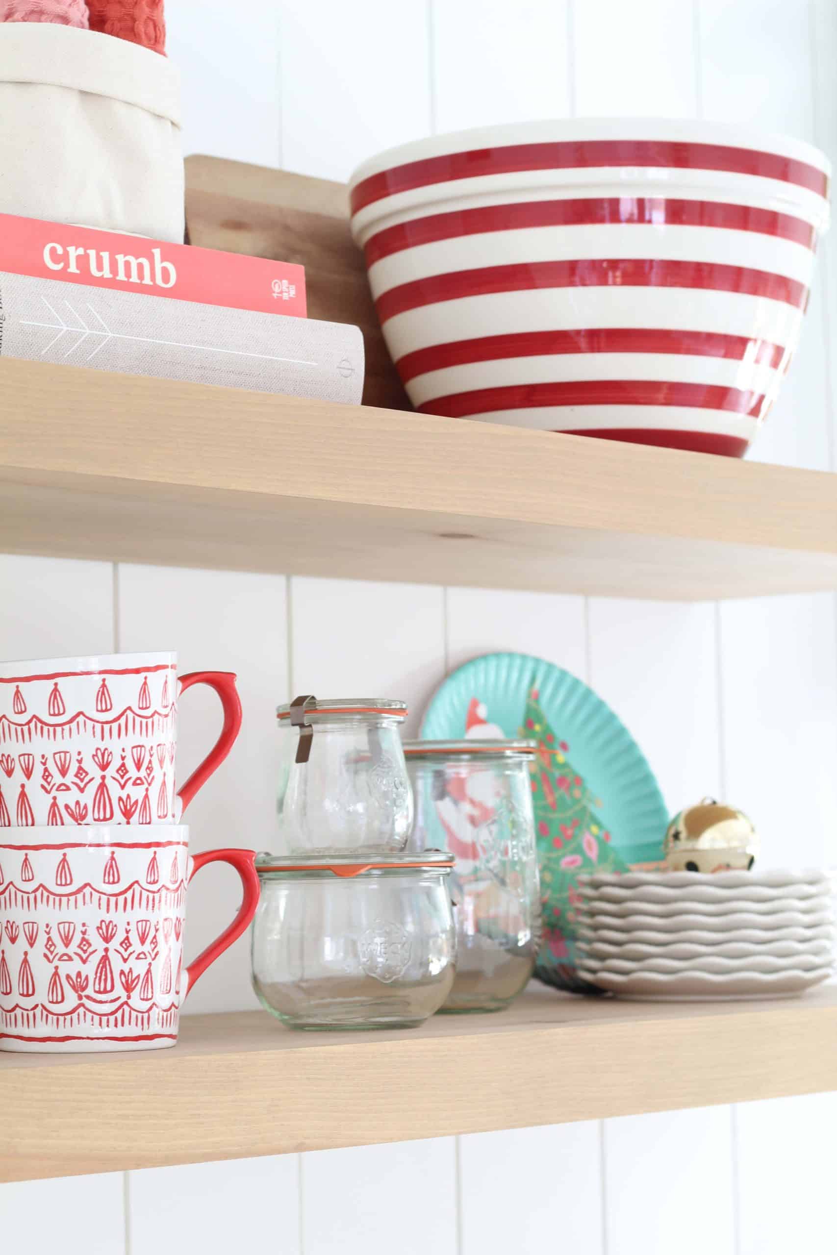 farmhouse kitchen with open shelving, crate and barrel red striped bowl, tulip wreck jars, melamine christmas plates