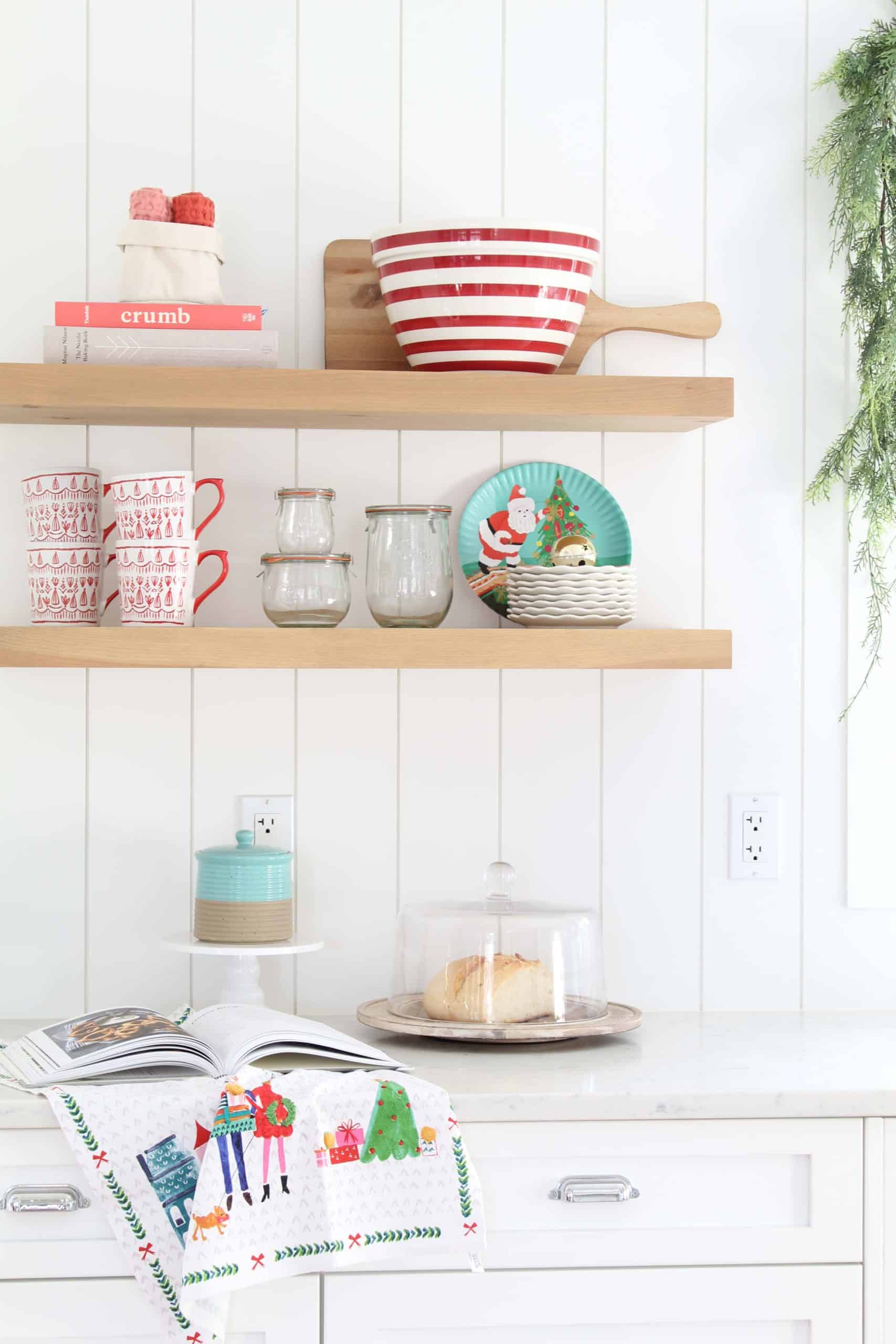 farmhouse kitchen with open shelving, crate and barrel red striped bowl, tulip wreck jars, melamine christmas plates, mr. boddington tea towel, anthropologie tea towel