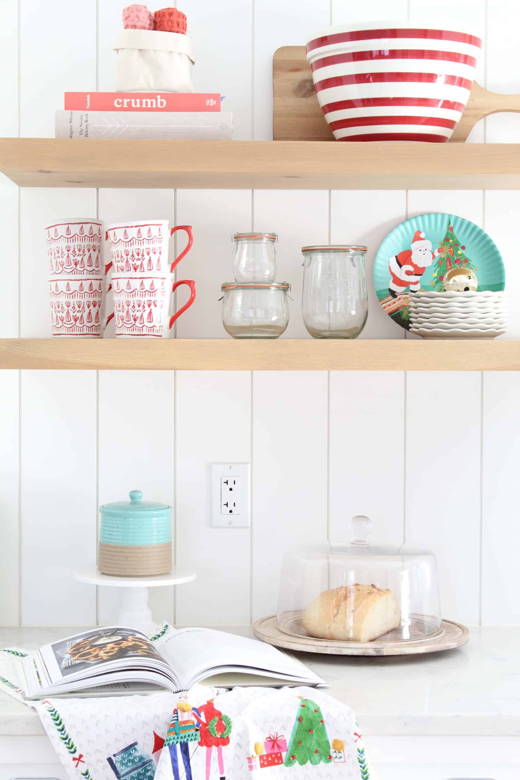 farmhouse kitchen with open shelving, crate and barrel red striped bowl, tulip wreck jars, melamine christmas plates, mr. boddington tea towel, anthropologie tea towel