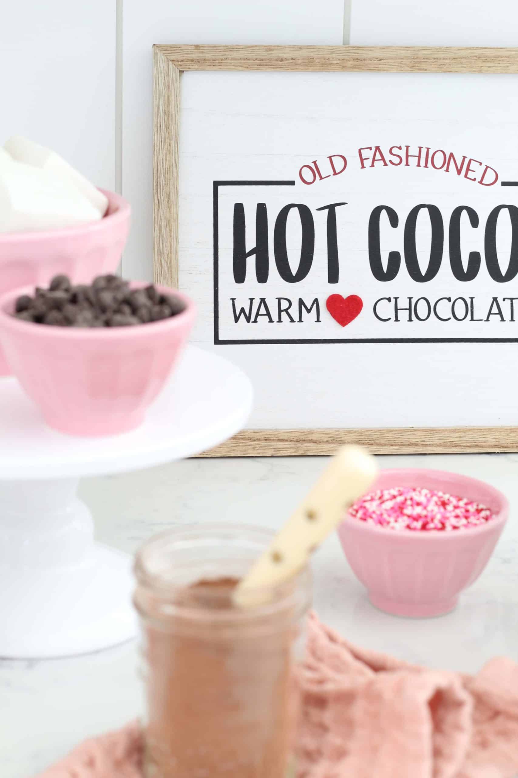 hot cocoa bar sign, pink anthropologie bowls, white cake stand