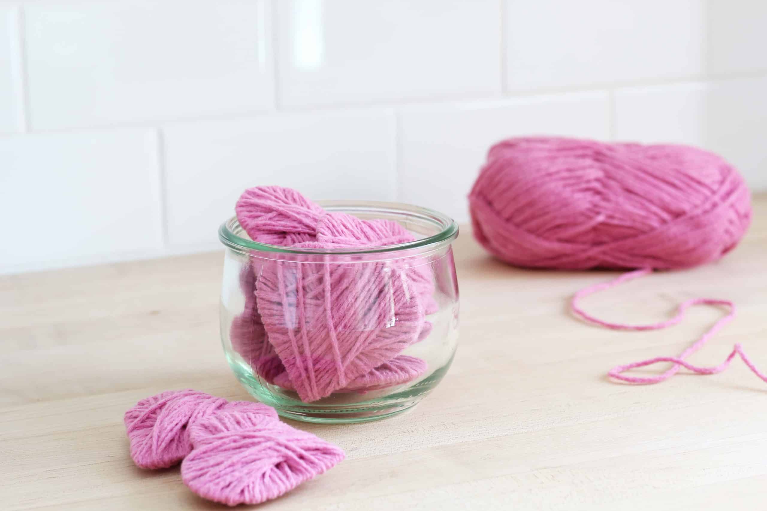 pink yarn hearts in glass jar