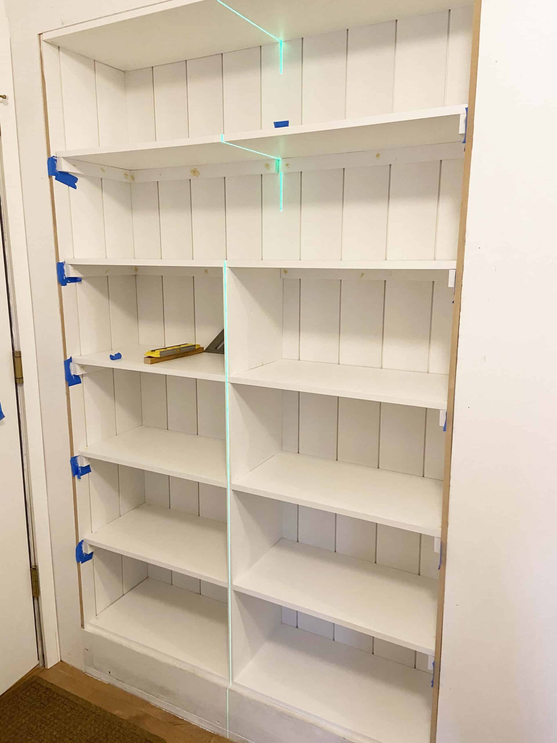 turn a hall closet into a built in bookshelf