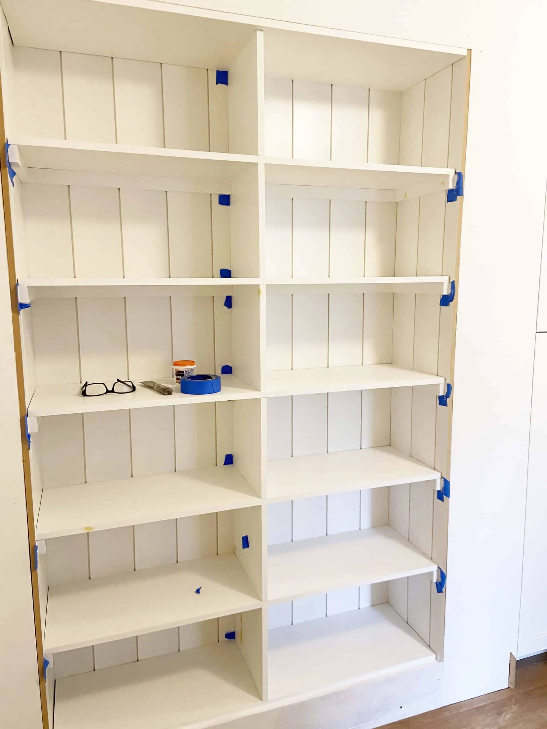 turn a hall closet into a built in bookshelf
