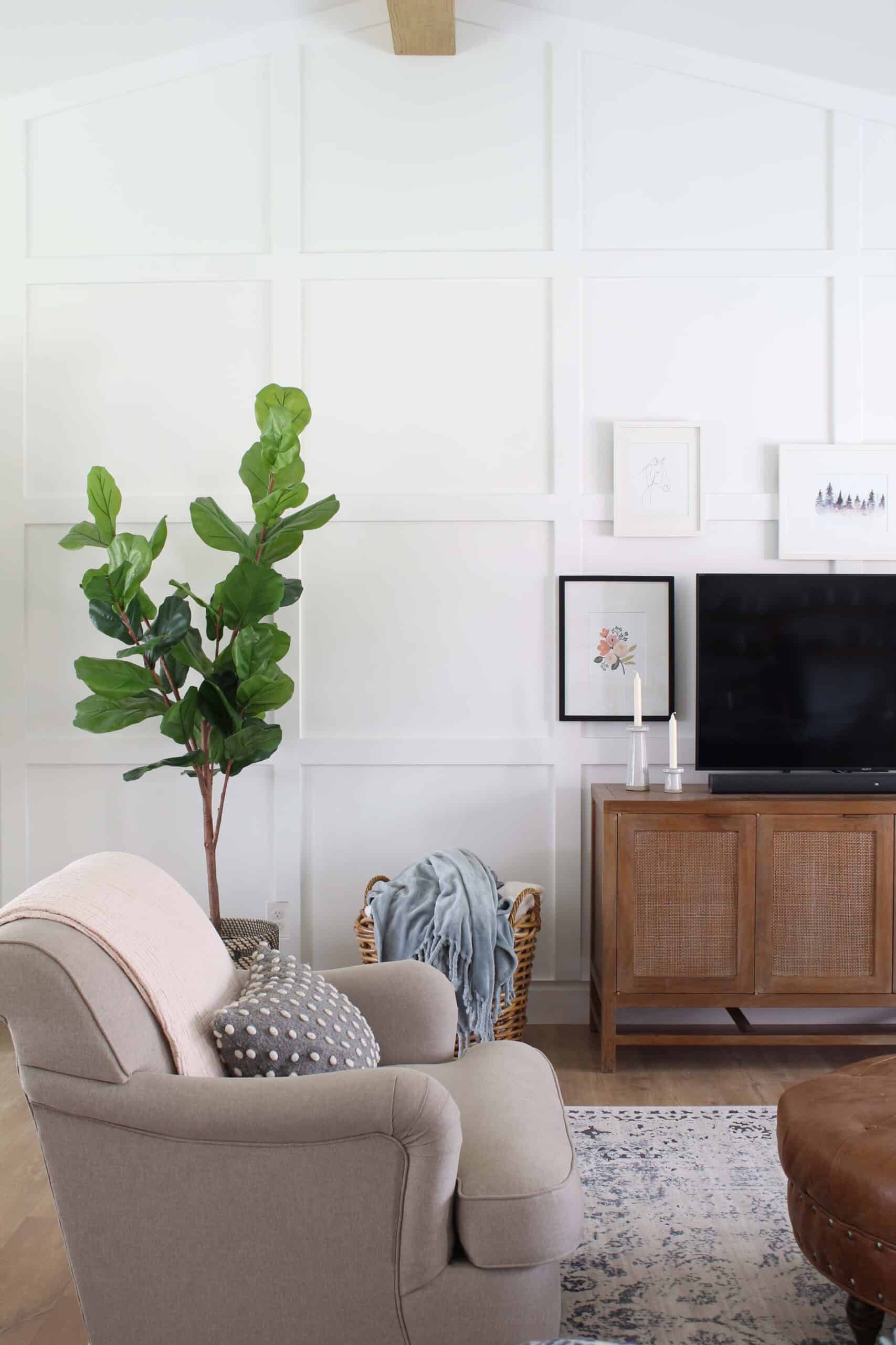 white living room with square box trim moulding, large faux fiddle leaf fig tree, 