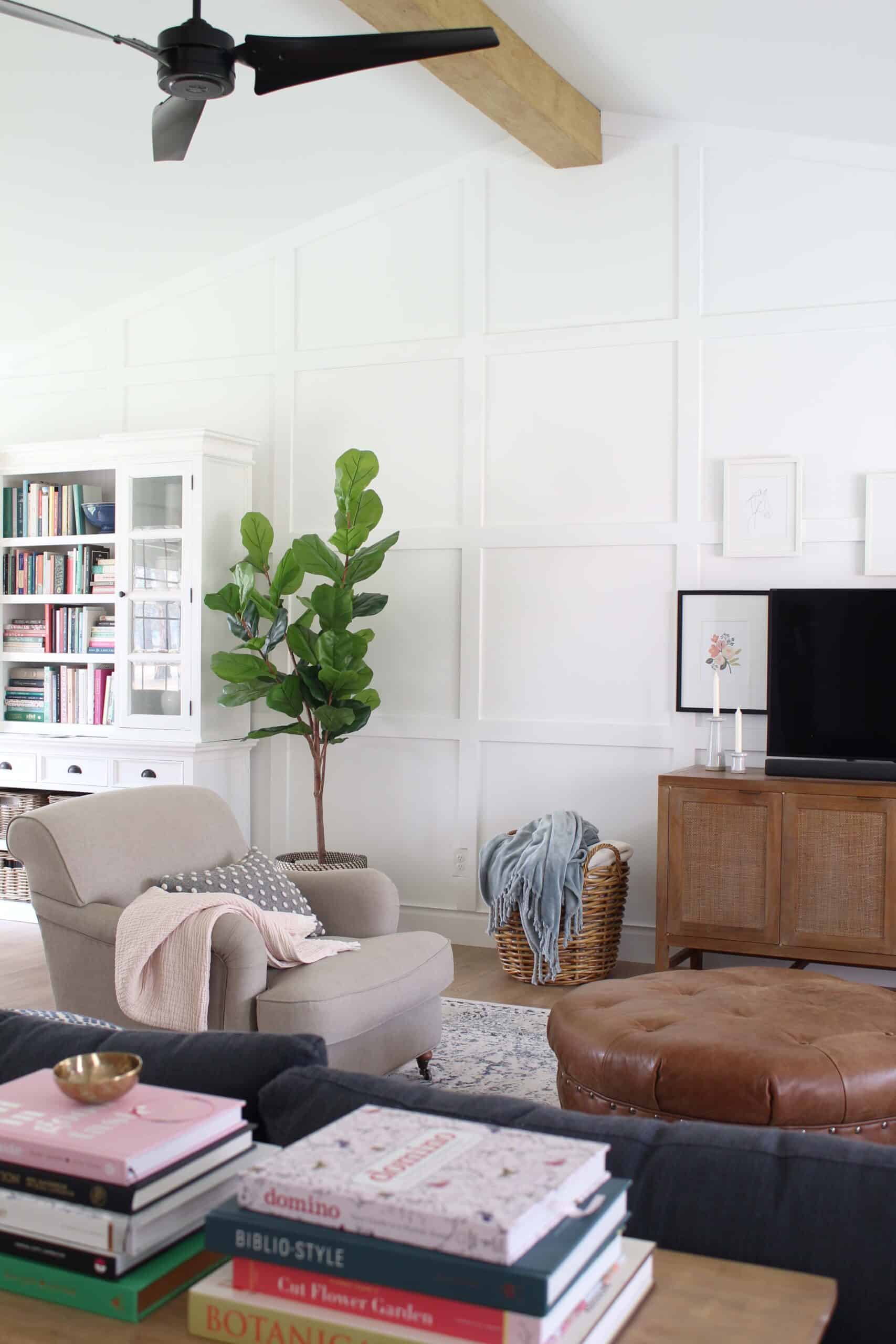 living room with white walls and white box trim moulding, board and batten accent wall